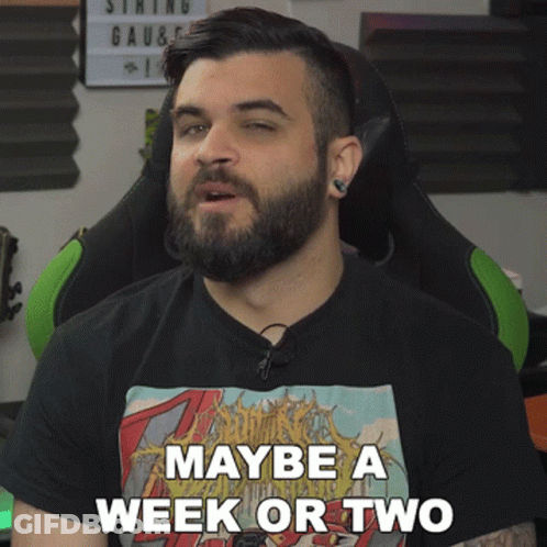 A Man With A Beard Wears A Black Shirt That Says Maybe A Week Or Two GIF