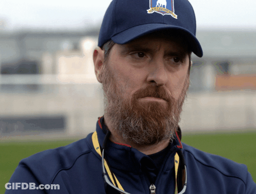 A Man With A Beard Wears A Blue Hat That Says Us Open On It GIF