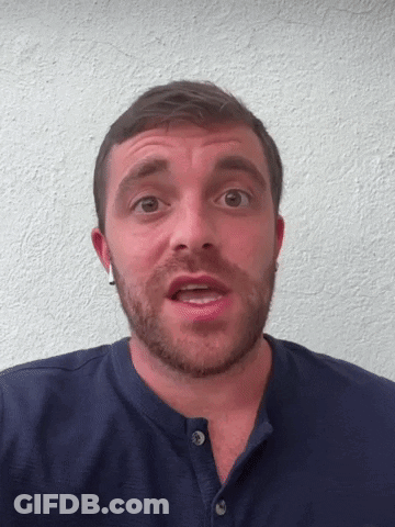 A Man With A Beard Wears A Blue Shirt GIF