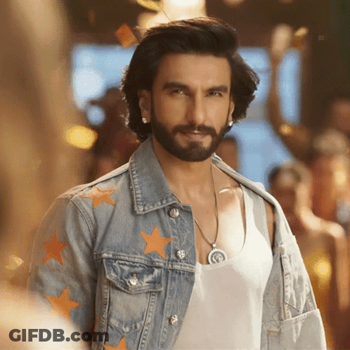 A Man With A Beard Wears A Denim Jacket With Orange Stars On It GIF