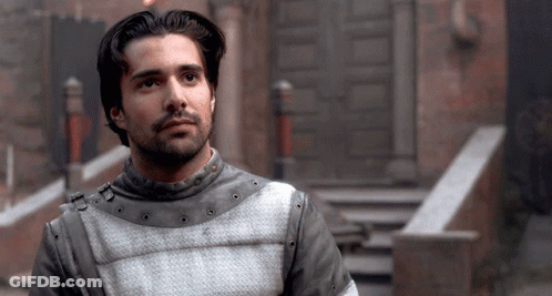 A Man With A Beard Wears A Gray And White Armor GIF