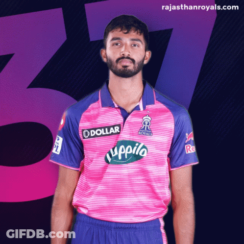 A Man With A Beard Wears A Pink And Blue Shirt That Says Dollar On It GIF