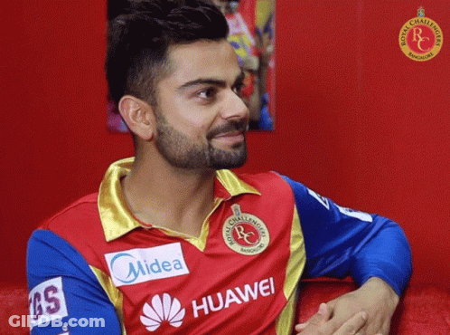 A Man With A Beard Wears A Red And Blue Shirt That Says Midea And Huawei GIF
