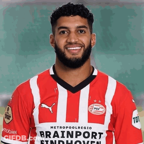 A Man With A Beard Wears A Red And White Striped Shirt That Says Brainport Findhoven GIF