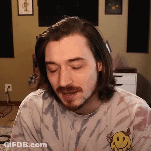 Man With Beard Wearing Tie Dye Shirt With Smiley Face GIF