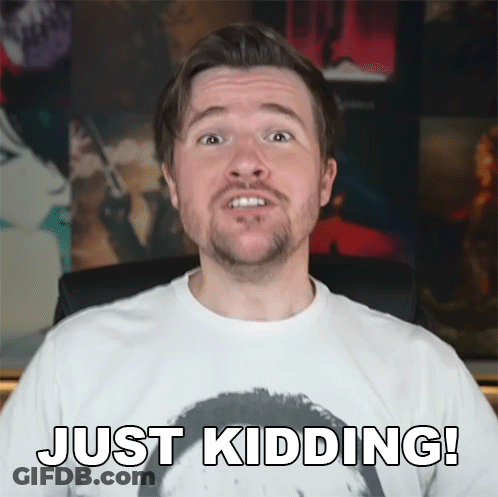 A Man With A Beard Wears A White Shirt That Says Just Kidding GIF