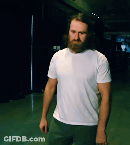 A Man With A Beard Wears A White T-Shirt GIF