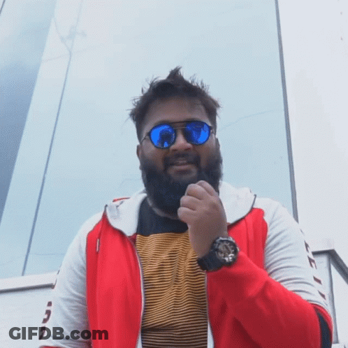 A Man With A Beard Wears Sunglasses And A Watch GIF