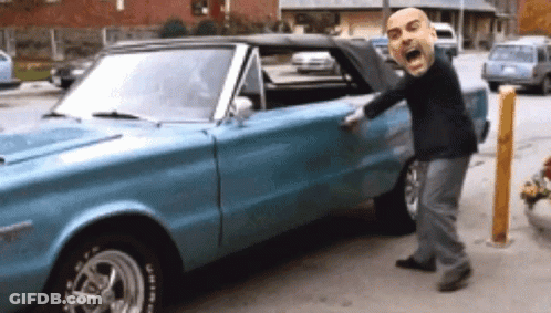 A Man With A Big Head Is Standing Next To A Blue Car With A Tire That Says Bfgoodrich On It GIF
