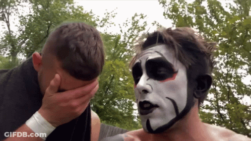 A Man With A Black And White Face Paint Covering His Face GIF