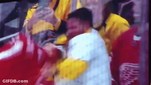 A Man With A Bloody Face Is Being Helped By A Group Of People . GIF