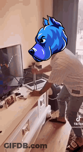 A Man With A Blue Dog Head Stands In Front Of A Laptop GIF