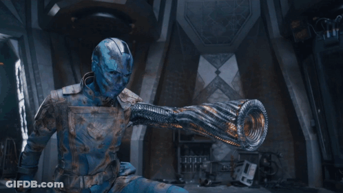 A Man With A Blue Face Is Holding A Light In His Hand . GIF