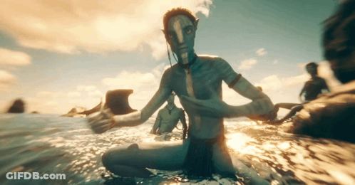 A Man With A Blue Face Is Sitting In The Ocean GIF