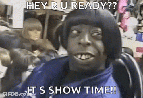 A Man With A Bob Hairstyle Is Sitting In A Chair And Making A Funny Face With A Caption . GIF
