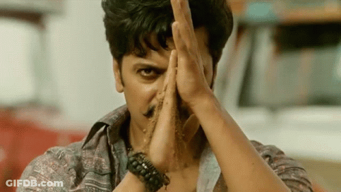 A Man With A Bracelet On His Wrist Holds His Hands In Front Of His Face GIF