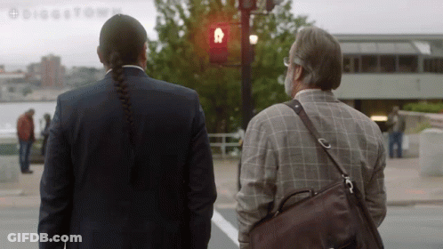 A Man With A Braided Hair Stands Next To A Man With A Beard GIF
