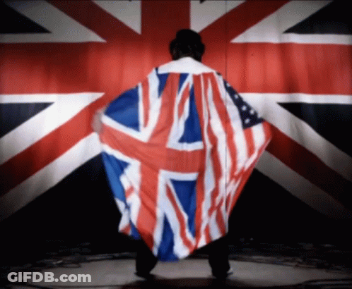 A Man With A British Flag Draped Over His Back GIF