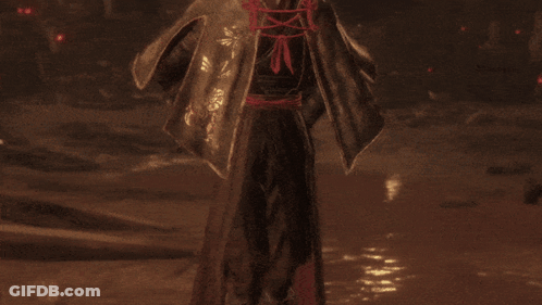 A Man With A Bun Is Holding Two Swords GIF