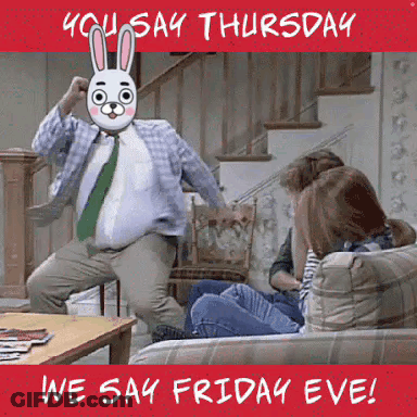 A Man With A Bunny Mask On His Face Is Dancing In A Living Room With People Sitting On A Couch . GIF