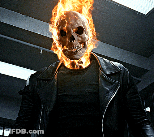 A Man With A Burning Skull On His Head Is Wearing A Leather Jacket GIF
