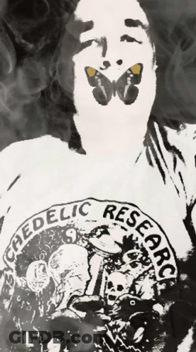 A Man With A Butterfly On His Face Is Wearing A Shirt That Says " Ephedelic Research " GIF
