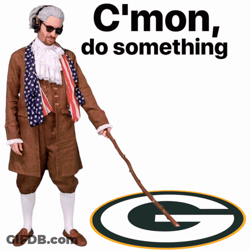A Man With A Cane Is Standing In Front Of A Packers Logo GIF