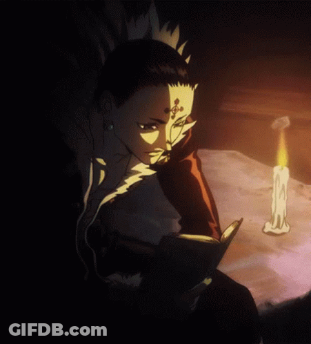 A Man With A Cross On His Forehead Is Reading A Book Next To A Candle GIF
