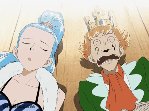 A Man With A Crown On His Head And A Woman Laying On The Floor GIF