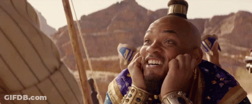 A Man With A Crown On His Head Is Smiling GIF