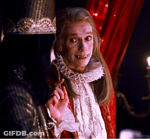 A Man With A Crown On His Head Is Talking To Another Man GIF