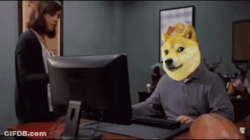 A Man With A Doge Head Sitting In Front Of A Computer Monitor GIF