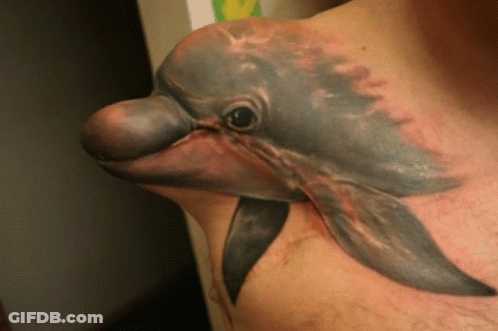 A Man With A Dolphin Tattoo On His Chest GIF