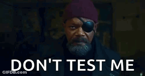 A Man With A Eye Patch And A Beard Is Standing In Front Of A Door . GIF