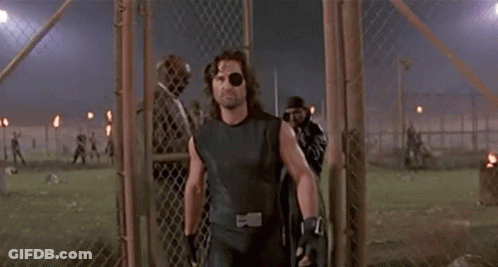 Man With Eye Patch Walking Through Fence GIF