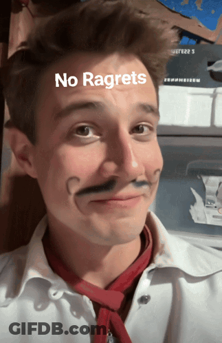 A Man With A Fake Mustache Has The Words No Regrets Written On His Face GIF