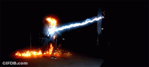 A Man With A Flaming Head Is Standing In Front Of A Ghost GIF