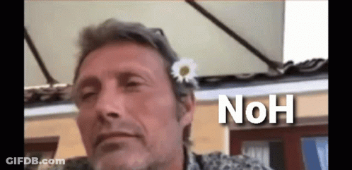 A Man With A Flower In His Hair And The Word " Noh " Below Him GIF