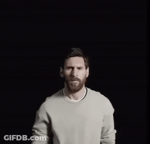 A Man With A Gold Crown On His Head Points Up GIF