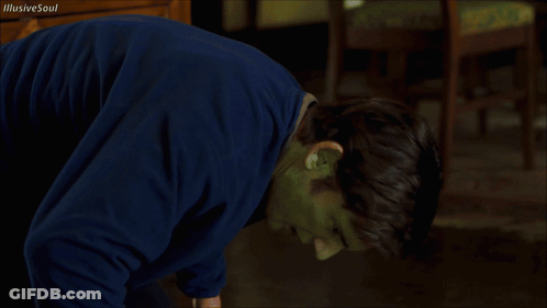 A Man With A Green Mask On His Face Is Looking At The Camera GIF