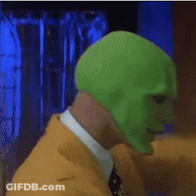 A Man With A Green Mask On His Face Wearing A Cowboy Hat GIF