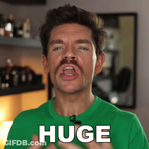 A Man With A Green Shirt Says Huge GIF