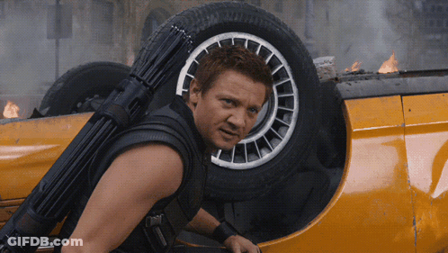 A Man With A Gun On His Back Is Standing Next To A Car GIF
