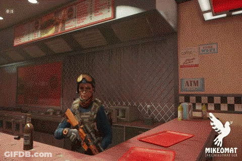 A Man With A Gun Stands In Front Of A Counter With A Sign That Says Atm On It GIF