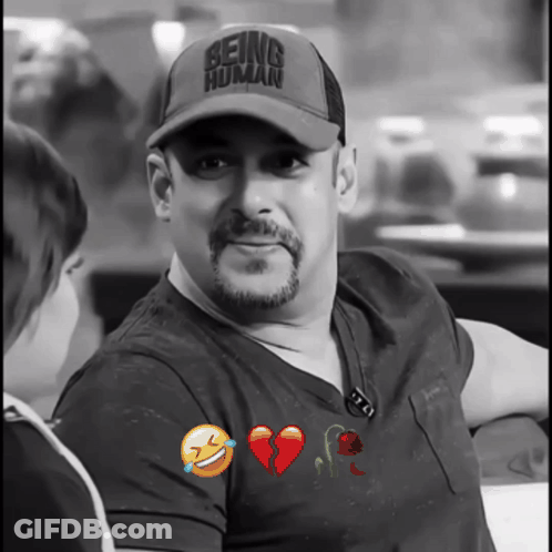 A Man With A Hat That Says Being Human GIF