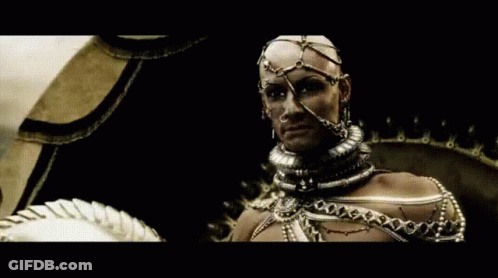 A Man With A Helmet On His Head Is Wearing A Lot Of Jewelry GIF