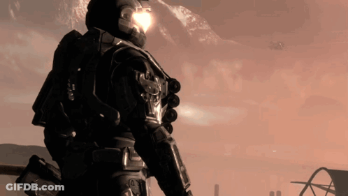 A Man With A Helmet On Stands In Front Of Mountains GIF