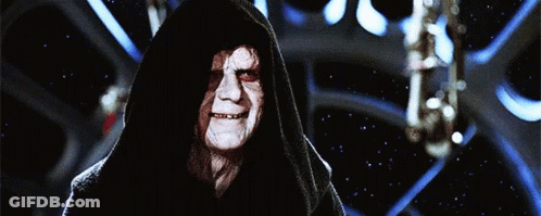 A Man With A Hood On His Head Is Smiling In Front Of A Starry Sky GIF