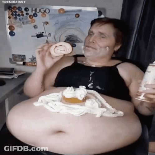 A Man With A Huge Belly Is Eating A Cake With Whipped Cream On It GIF