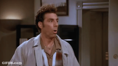 A Man With A Lanyard Around His Neck Is Standing In Front Of A Door GIF